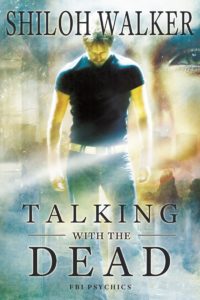 Man in black t-shirt and jeans, looking don. Otherwordly background with a woman's face superimposed over it. Shiloh Walker FBI Psychics Psychic Romance.