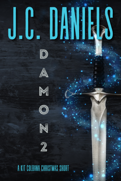 shows a sword against a wooden background with mystical elements.  Title in gray - DAMON 2, A KIT COLBANA CHRISTMAS SHORT